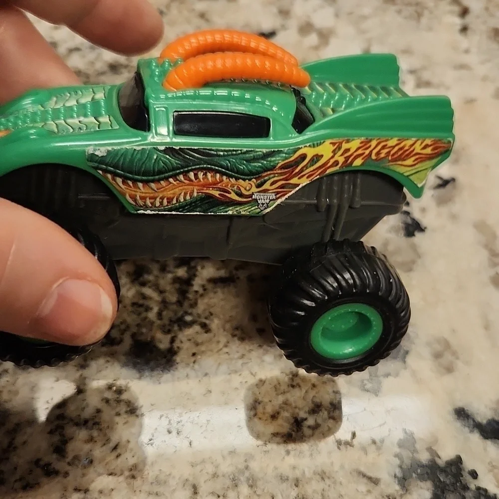 Monster jam plastic Rev up trucks has paper stickers ripping 2 cars